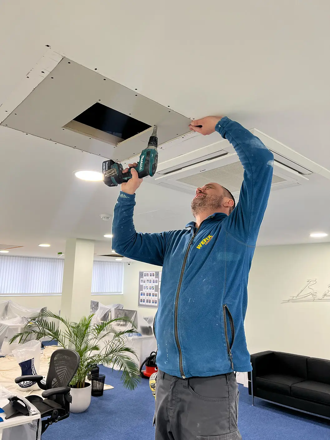 WeFix engineer installing a wall-mounted air conditioning unit