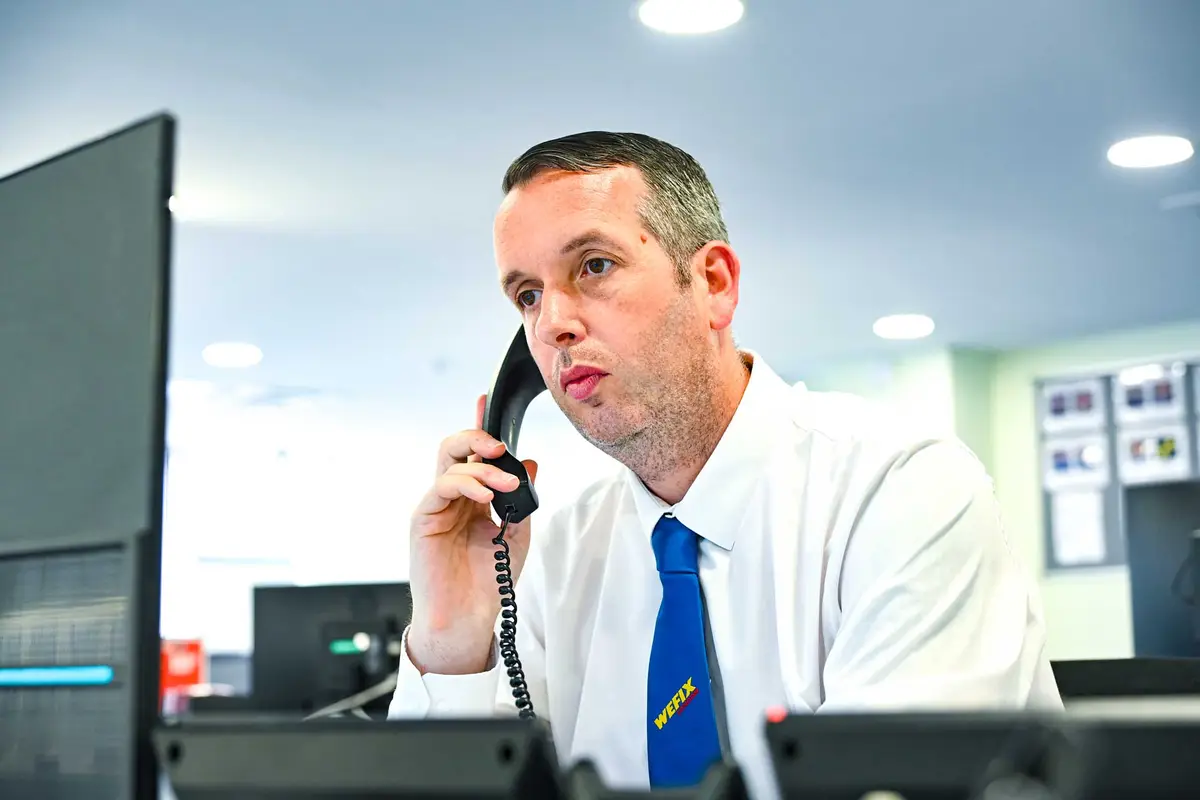 WeFix call centre manager taking a customer call at the Newport Street office