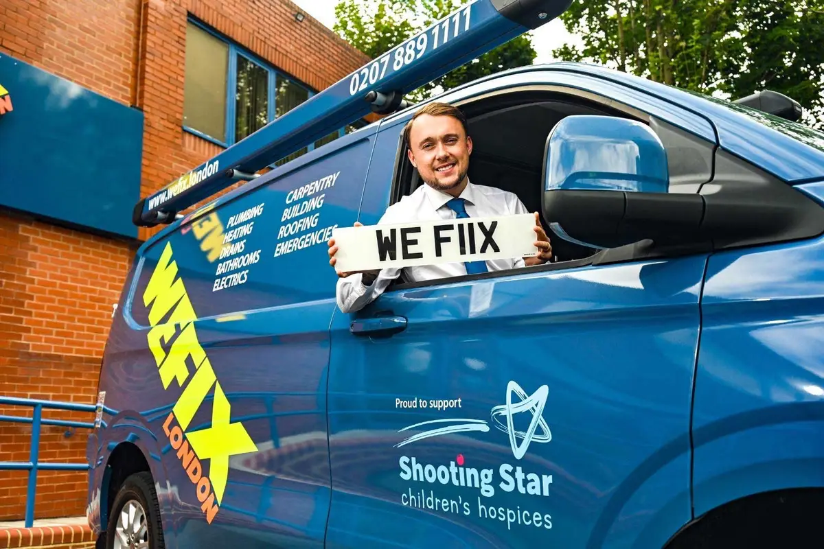 Smiling WeFix engineer in the cab of a WeFix van